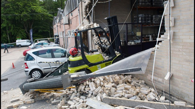 Clark forklift truck crashing into a warehouse wall after its brake master cylinder failed.